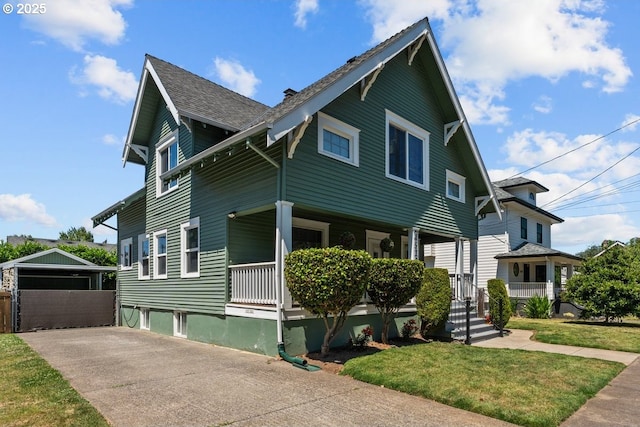 4529 SE 44th Ave, Portland, OR 97206 - view of front of property featuring a porch, an outbuilding, a front yard, and a shingled roof