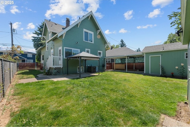 4529 SE 44th Ave, Portland, OR 97206 - rear view of property featuring a gazebo, a fenced backyard, a patio area, and a chimney