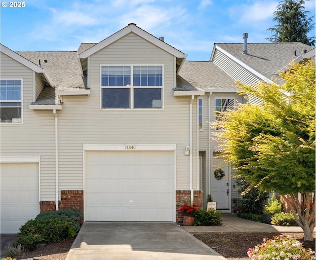 14640 SW Redbud Way, Beaverton, OR 97007 - view of front of home featuring roof with shingles, an attached garage, brick siding, and concrete driveway