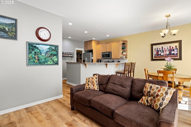 14640 SW Redbud Way, Beaverton, OR 97007 - living room with light wood-style flooring, recessed lighting, and a chandelier