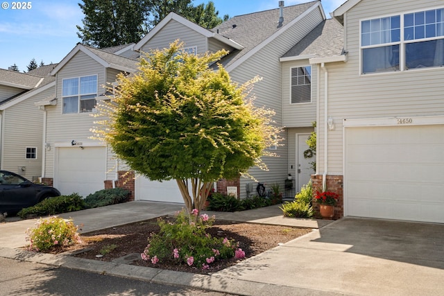 14640 SW Redbud Way, Beaverton, OR 97007 - townhome / multi-family property with a garage, concrete driveway, and a shingled roof
