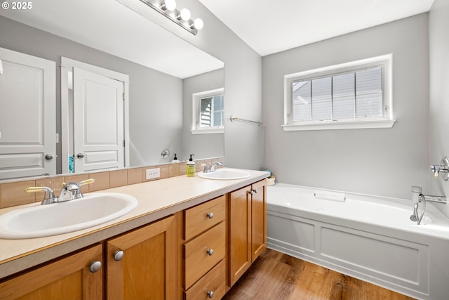 14640 SW Redbud Way, Beaverton, OR 97007 - full bath with double vanity, a garden tub, and wood finished floors
