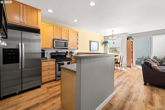 14640 SW Redbud Way, Beaverton, OR 97007 - kitchen featuring appliances with stainless steel finishes, light wood-type flooring, light brown cabinets, a chandelier, and decorative backsplash