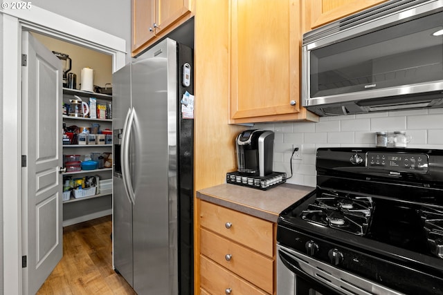 14640 SW Redbud Way, Beaverton, OR 97007 - kitchen featuring stainless steel appliances, tasteful backsplash, and light wood-style flooring