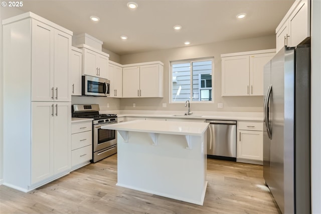 31709 NW Turel Dr, North Plains, OR 97133 - kitchen with light wood-style flooring, a sink, recessed lighting, appliances with stainless steel finishes, and light countertops