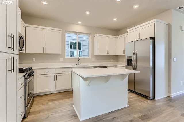 31709 NW Turel Dr, North Plains, OR 97133 - kitchen featuring recessed lighting, a sink, light countertops, light wood-style floors, and appliances with stainless steel finishes