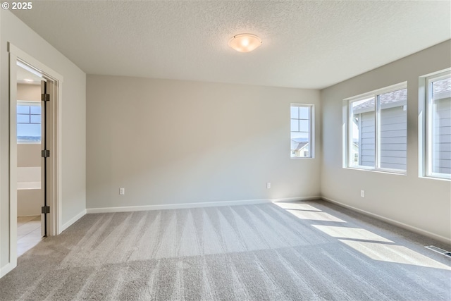 31709 NW Turel Dr, North Plains, OR 97133 - spare room with baseboards, visible vents, a textured ceiling, and carpet