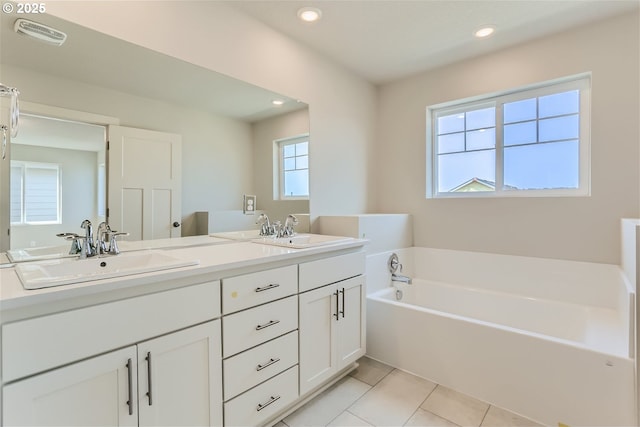 31709 NW Turel Dr, North Plains, OR 97133 - full bathroom featuring tile patterned floors, visible vents, a garden tub, a sink, and recessed lighting