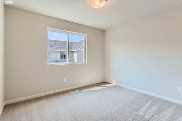 31709 NW Turel Dr, North Plains, OR 97133 - spare room featuring visible vents, carpet flooring, and baseboards