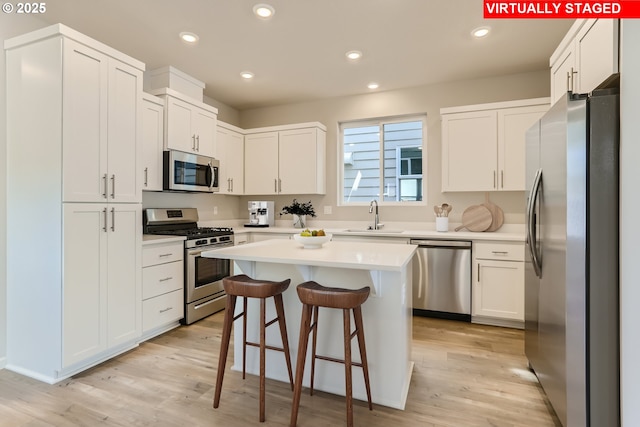 31709 NW Turel Dr, North Plains, OR 97133 - kitchen with a sink, a kitchen breakfast bar, recessed lighting, and stainless steel appliances