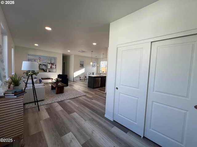 living area with recessed lighting and dark wood-style flooring