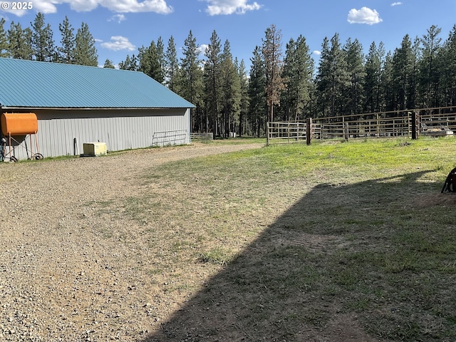 39798 Bear Gulch Rd, Sumpter, OR 97877 - view of yard featuring a pole building, an outdoor structure, and a forest view
