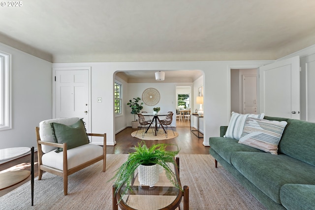 3575 NE Emerson St, Portland, OR 97211 - living area featuring arched walkways, light wood-style flooring, and baseboards