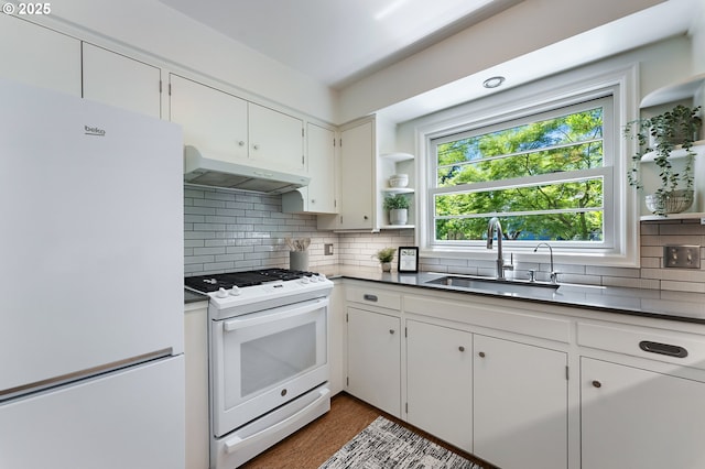 3575 NE Emerson St, Portland, OR 97211 - kitchen with white appliances, a sink, under cabinet range hood, open shelves, and backsplash