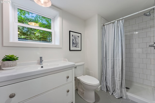 3575 NE Emerson St, Portland, OR 97211 - bathroom featuring toilet, tile patterned flooring, tiled shower, and vanity