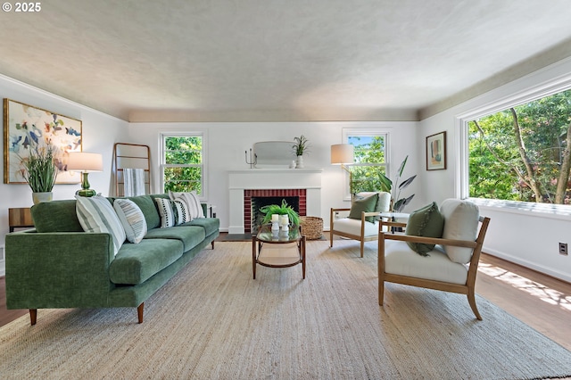 3575 NE Emerson St, Portland, OR 97211 - living area with plenty of natural light, wood finished floors, baseboards, and a brick fireplace