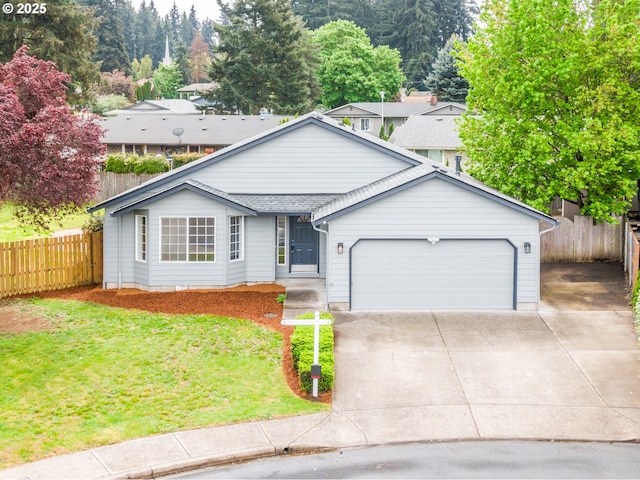 view of front of property featuring a garage, a front lawn, fence, and driveway