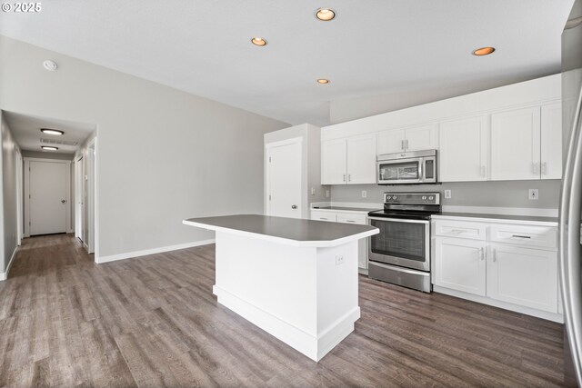 kitchen with recessed lighting, appliances with stainless steel finishes, wood finished floors, and white cabinets
