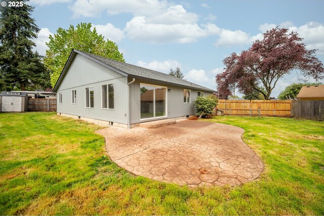 back of property featuring crawl space, a patio area, a fenced backyard, a storage unit, and a yard