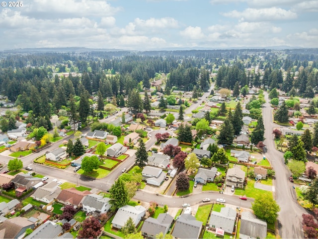 drone / aerial view with a forest view and a residential view
