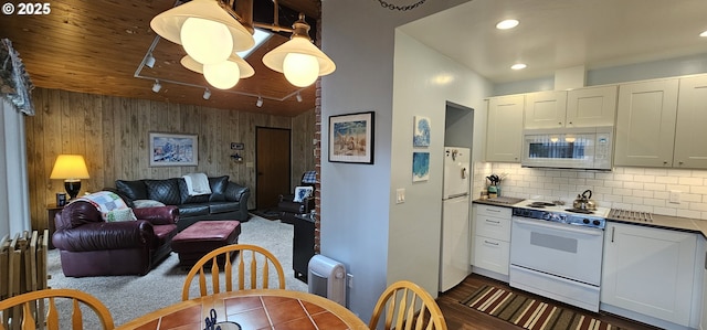 5840 Hacienda Ave, Lincoln City, OR 97367 - kitchen with white appliances, dark countertops, rail lighting, recessed lighting, and backsplash