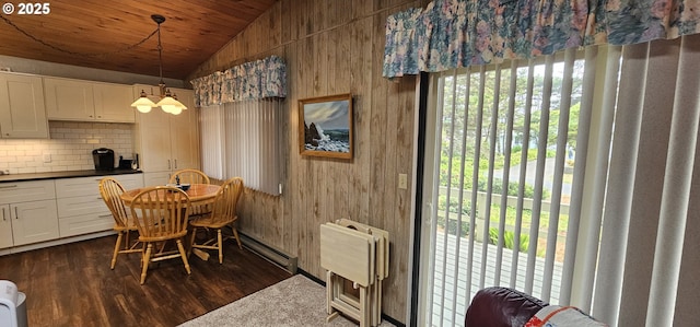 5840 Hacienda Ave, Lincoln City, OR 97367 - dining room featuring vaulted ceiling, baseboard heating, dark wood-style flooring, wood walls, and wooden ceiling