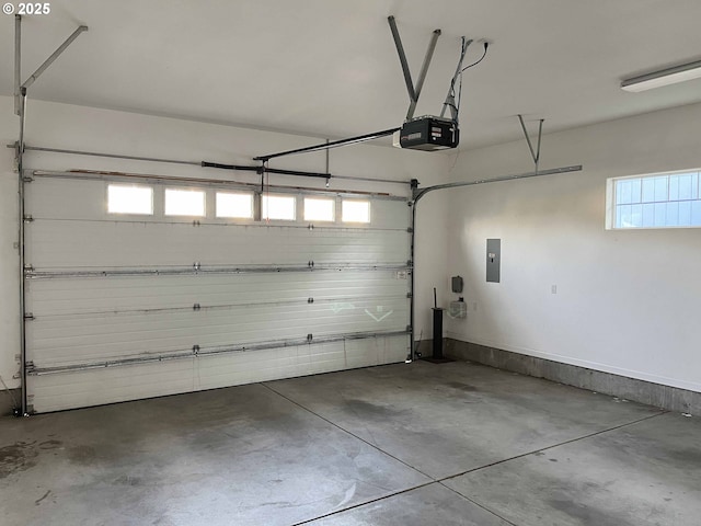 garage with electric panel and a garage door opener