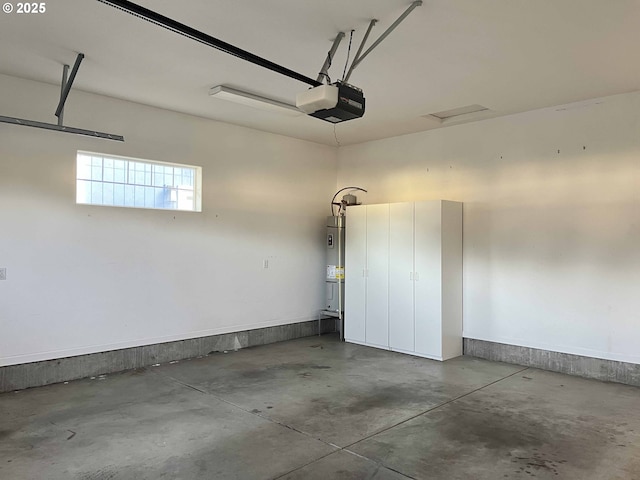 garage featuring water heater and a garage door opener