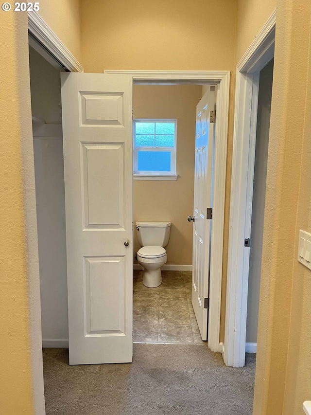 bathroom featuring tile patterned floors and toilet