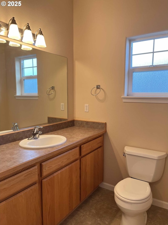 bathroom with tile patterned flooring, vanity, and toilet