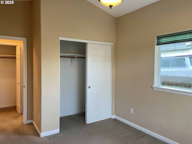 unfurnished bedroom with carpet flooring and a closet