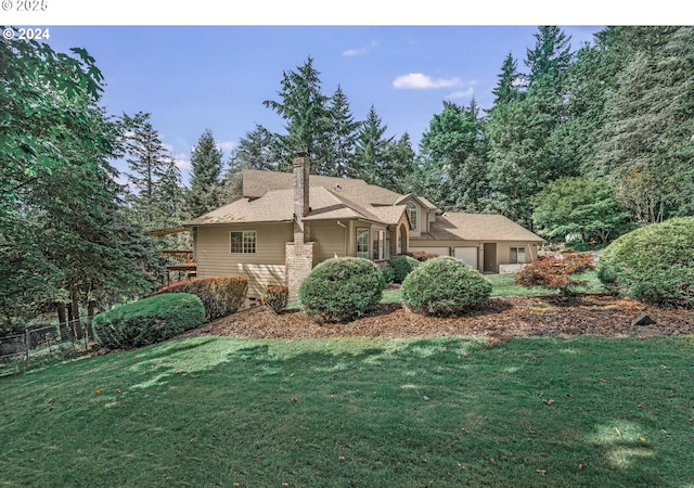 view of front of home with a front yard and a garage