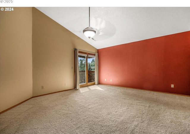 carpeted spare room with ceiling fan and lofted ceiling