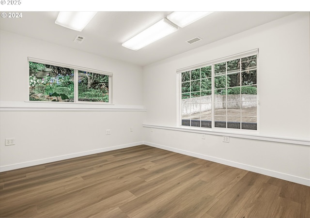 spare room with hardwood / wood-style flooring