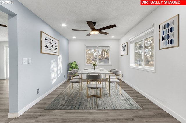 dining space featuring ceiling fan, dark hardwood / wood-style flooring, and a textured ceiling