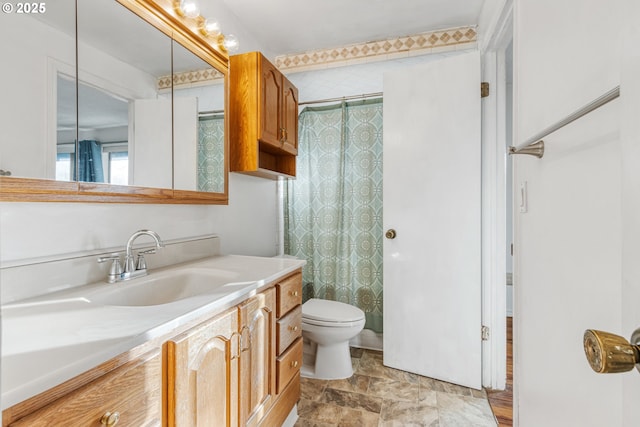 bathroom with toilet, vanity, and a shower with curtain