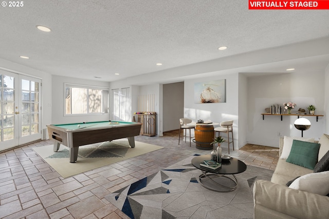 rec room with billiards, french doors, and a textured ceiling