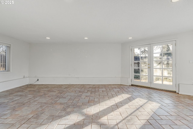 unfurnished room with plenty of natural light and french doors