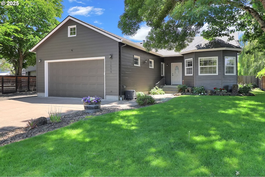 1555 W 13th Ave, Junction City, OR 97448 - ranch-style home featuring concrete driveway and a garage