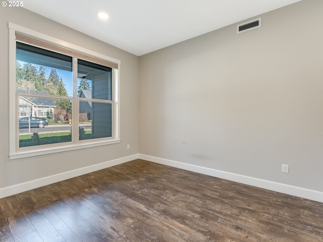 empty room with dark hardwood / wood-style floors