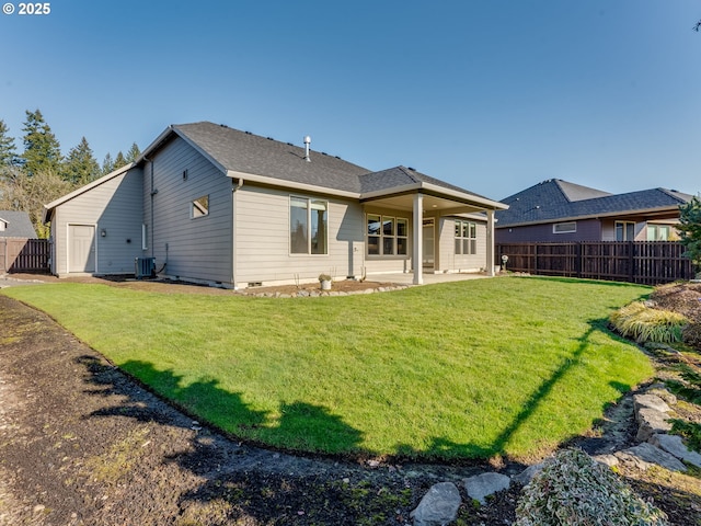 back of house with a yard and a patio area