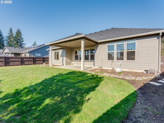 rear view of house featuring a yard and a patio area