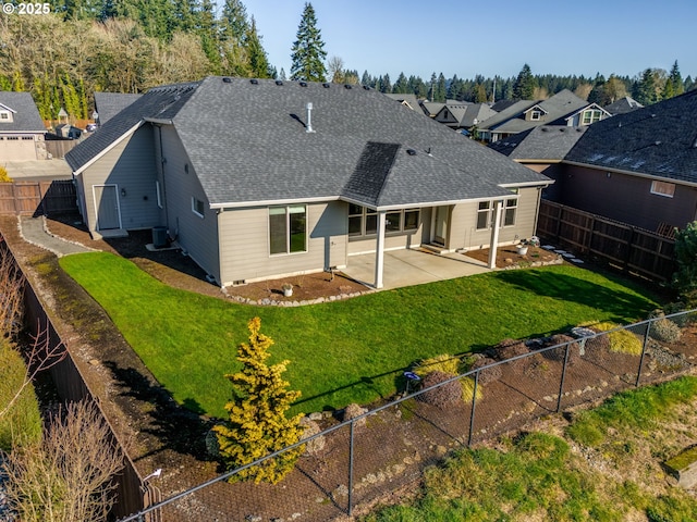 back of house with cooling unit, a patio area, and a lawn