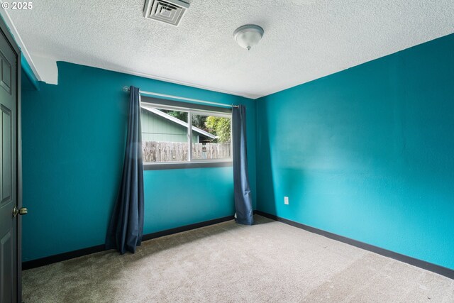 567 NW Cedar Ct, Warrenton, OR 97146 - carpeted spare room featuring a textured ceiling