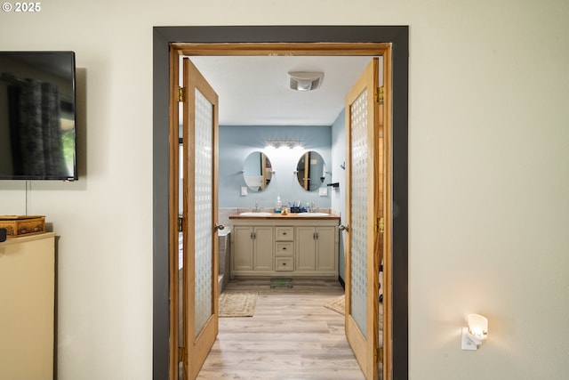 567 NW Cedar Ct, Warrenton, OR 97146 - hallway with light wood-type flooring and a sink