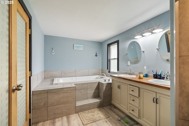 567 NW Cedar Ct, Warrenton, OR 97146 - full bath with wood finished floors, a bath, and double vanity