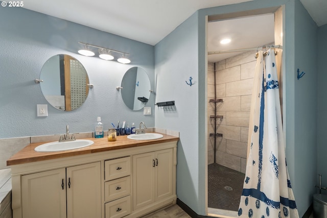 567 NW Cedar Ct, Warrenton, OR 97146 - bathroom featuring double vanity and tiled shower