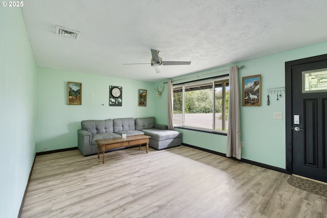 567 NW Cedar Ct, Warrenton, OR 97146 - living area featuring light wood-style flooring, ceiling fan, healthy amount of natural light, and a textured ceiling