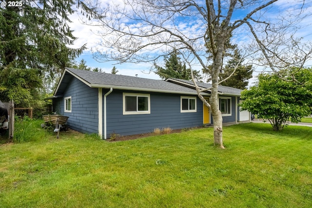 567 NW Cedar Ct, Warrenton, OR 97146 - back of property featuring a yard and a shingled roof