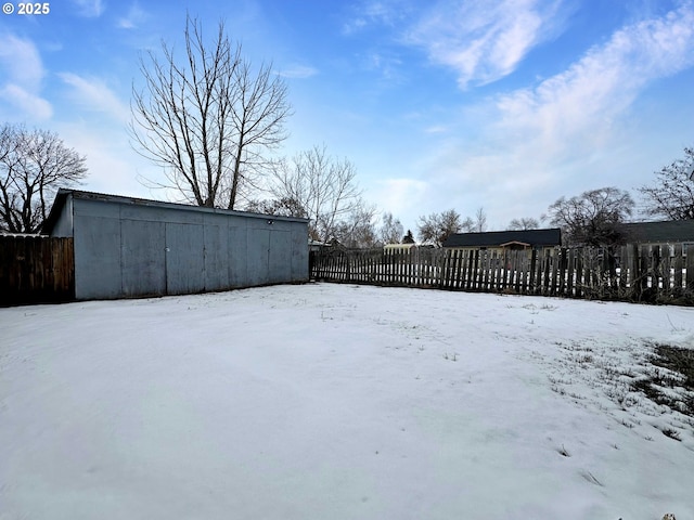 yard layered in snow featuring fence